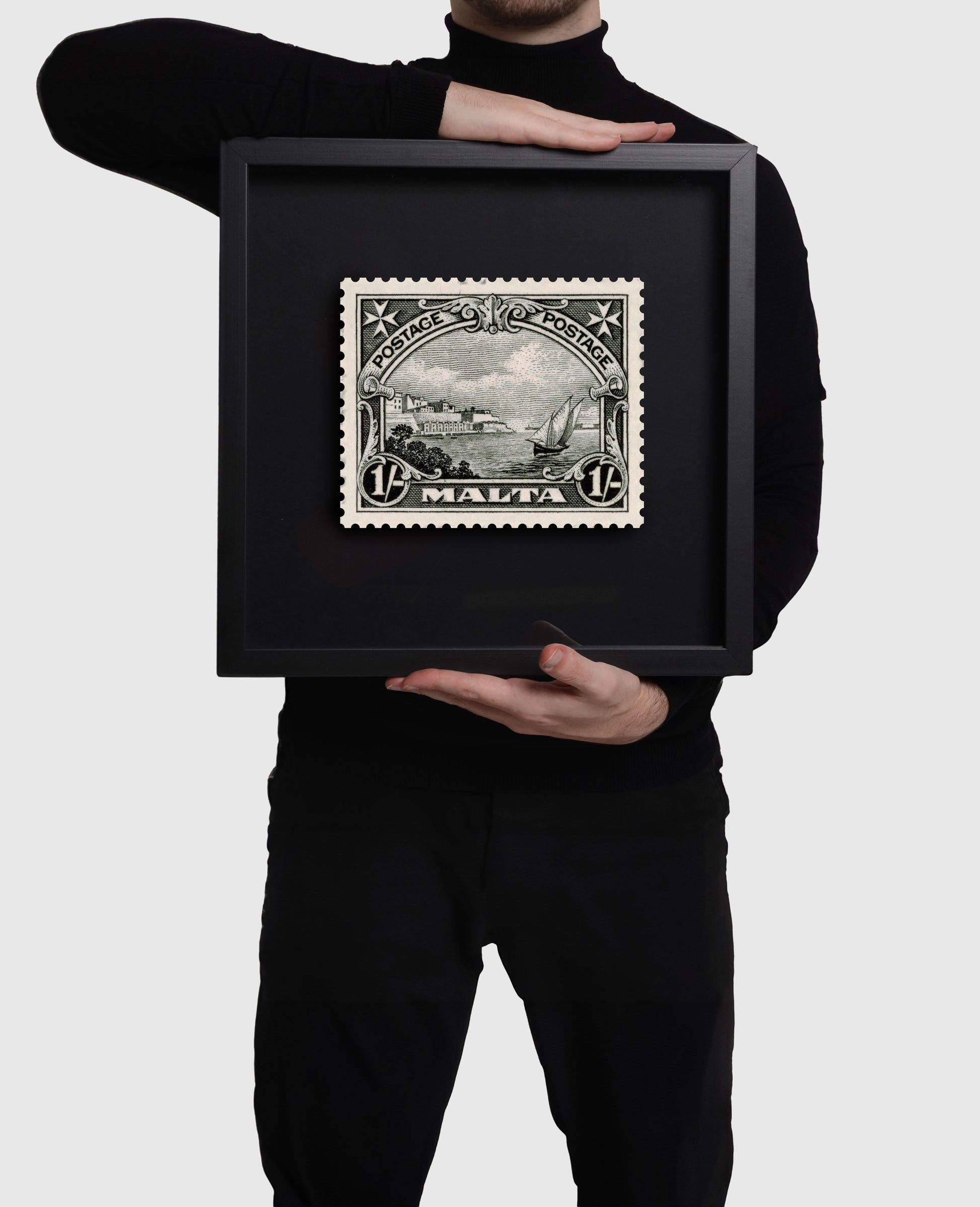 Person holding large black frame of Grand Harbour Malta Stamp