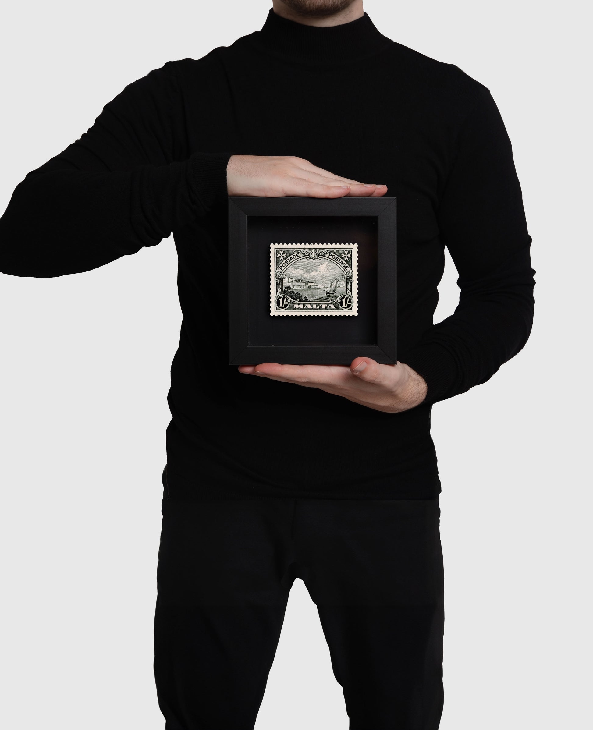 Person holding small black frame of Grand Harbour Malta Stamp